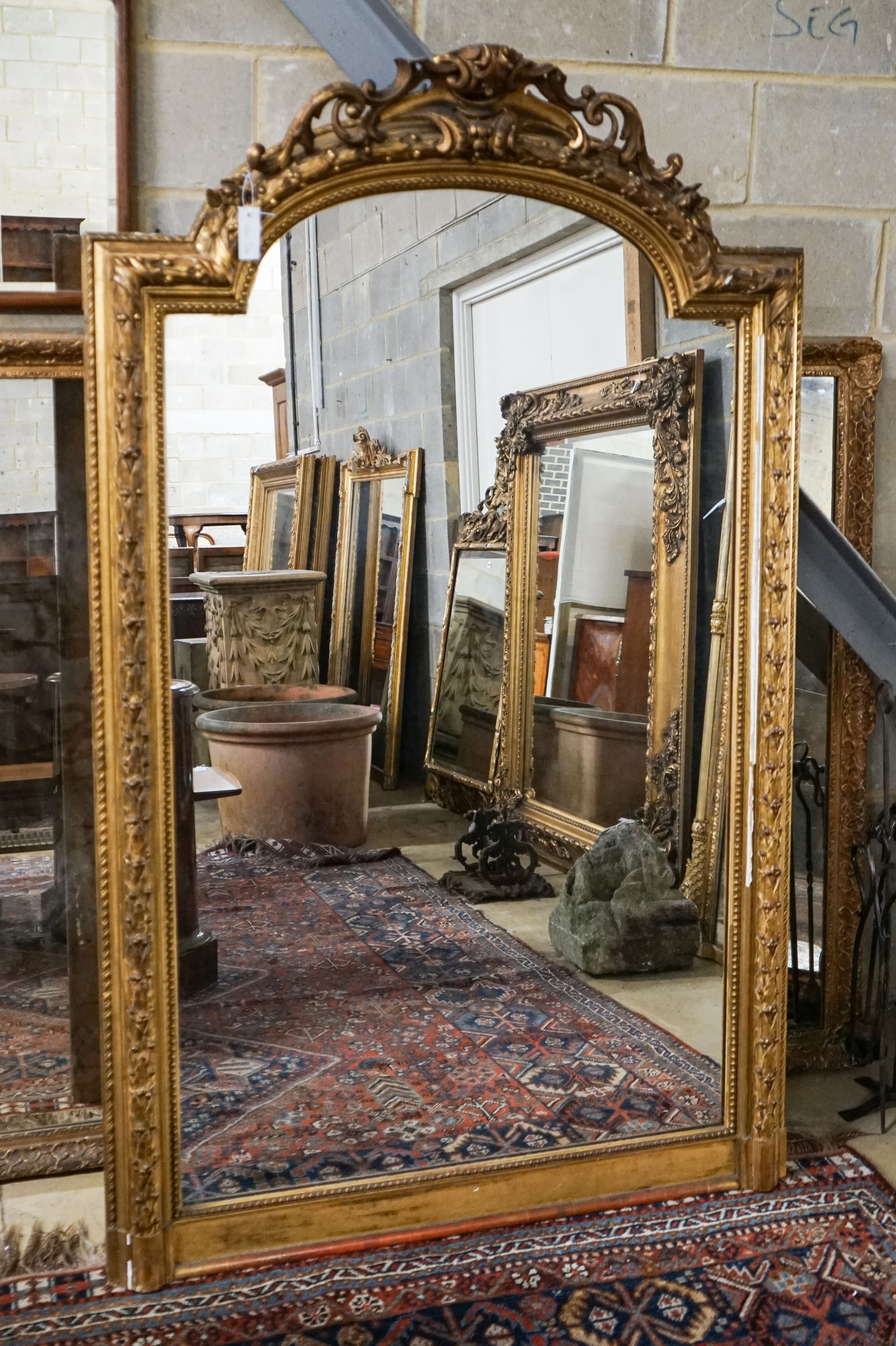 A Victorian giltwood and gesso overmantel mirror with arched scroll pediment, width 112cm, height 180cm